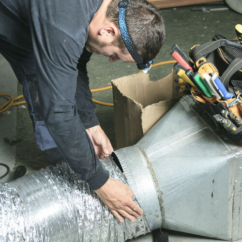 A Technician Attaches Ductwork.