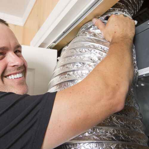 A Technician Working on an Air Duct.
